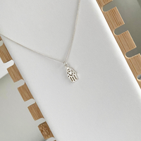 Sterling silver hamsa pendant necklace with a delicate chain, a perfect gift for birthdays or special occasions. KookyTwo Jewellery.