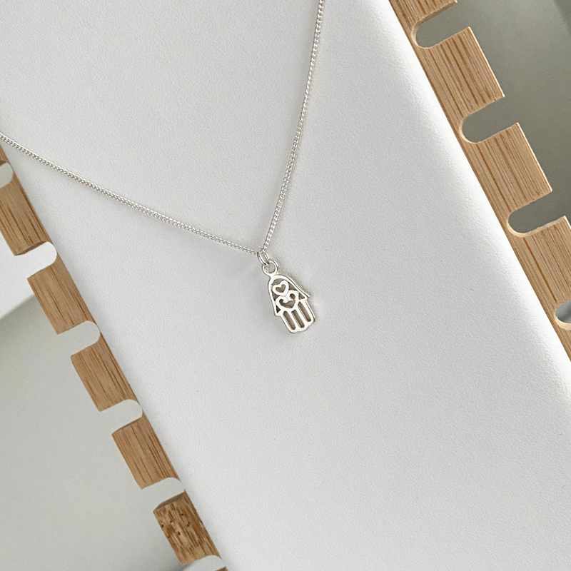 Sterling silver hamsa pendant necklace with a delicate chain, a perfect gift for birthdays or special occasions. KookyTwo Jewellery.