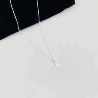 Silver necklace with lightning bolt charm for everyday styling. Gift for Harry Potter fan.