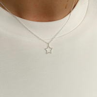 Dainty silver star necklace with a delicate chain, perfect for gifting. KookyTwo.