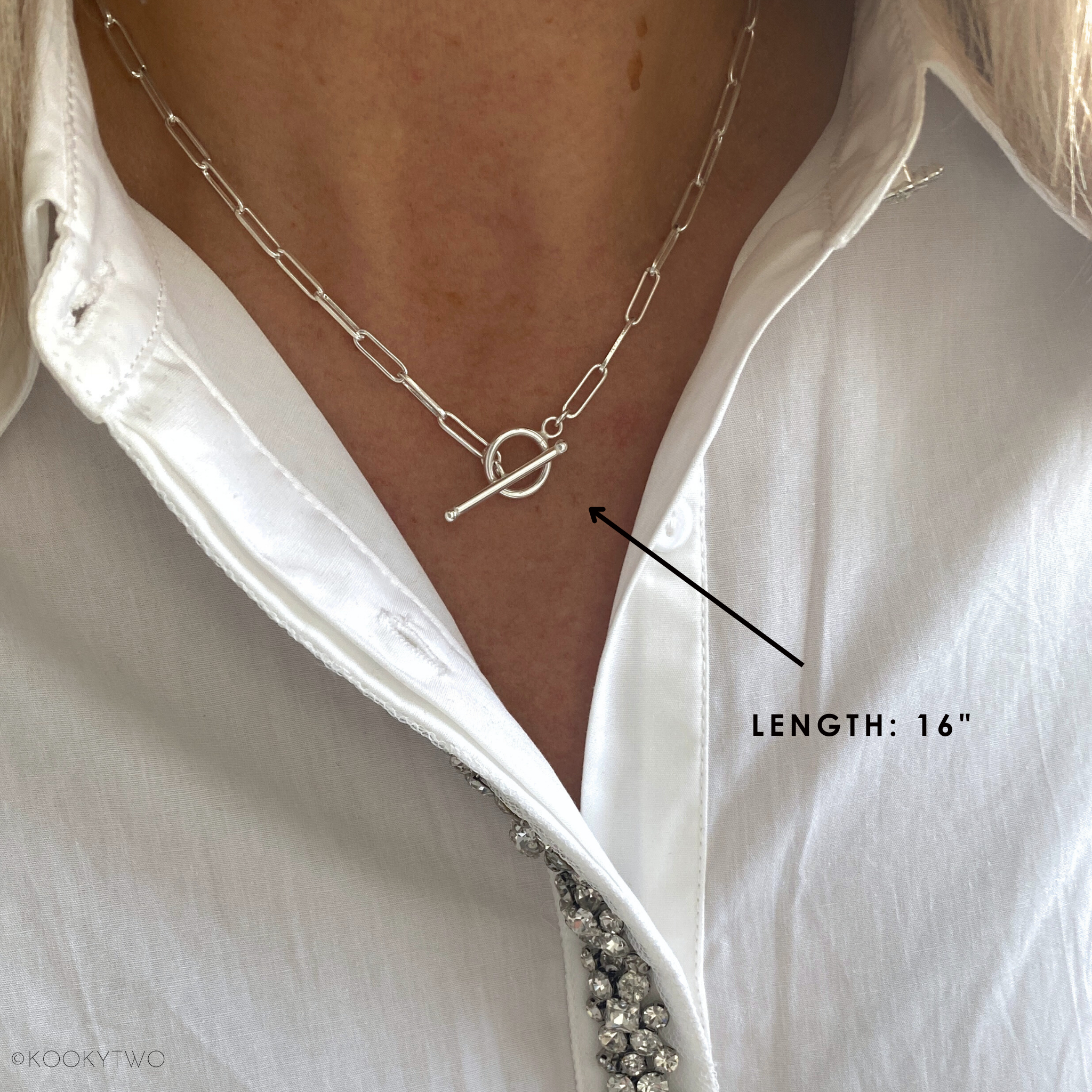 Sterling Silver T bar necklace on a person wearing a white shirt, with a  label indicating necklace length of 16" chain.