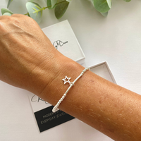 Stylish sterling silver bead bracelet with a delicate star charm, perfect for everyday wear or gifting. KookyTwo.