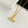 On trend T bar necklace in gold on background to show the high-quality materials and contemporary design. KookyTwo.