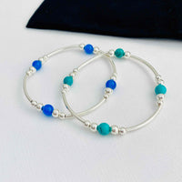 Set of two bracelets in sterling silver with turquoise gemstone beads and blue onyx gemstone beads. KookyTwo Jewellery.