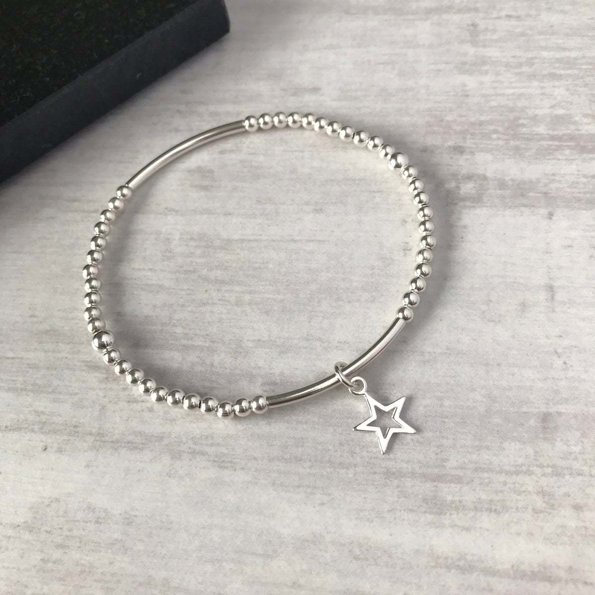 A beautiful sterling silver bead bracelet with a star charm, giving a timeless look for your everyday wear. KookyTwo.