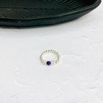 Stretch elastic bead ring with sterling silver beads and purple stone. KookyTwo.
