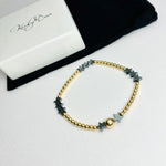 Contemporary gold bead bracelet with hematite star beads.