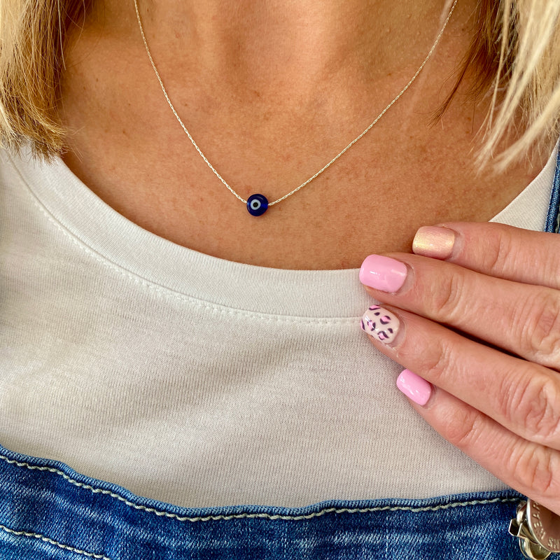 Blue bead necklace with blue evil eye bead on sterling silver chain.