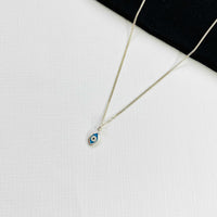 Evil eye jewellery necklace with blue eye charm on silver chain in sterling silver. Ladies eye necklace. KookyTwo.