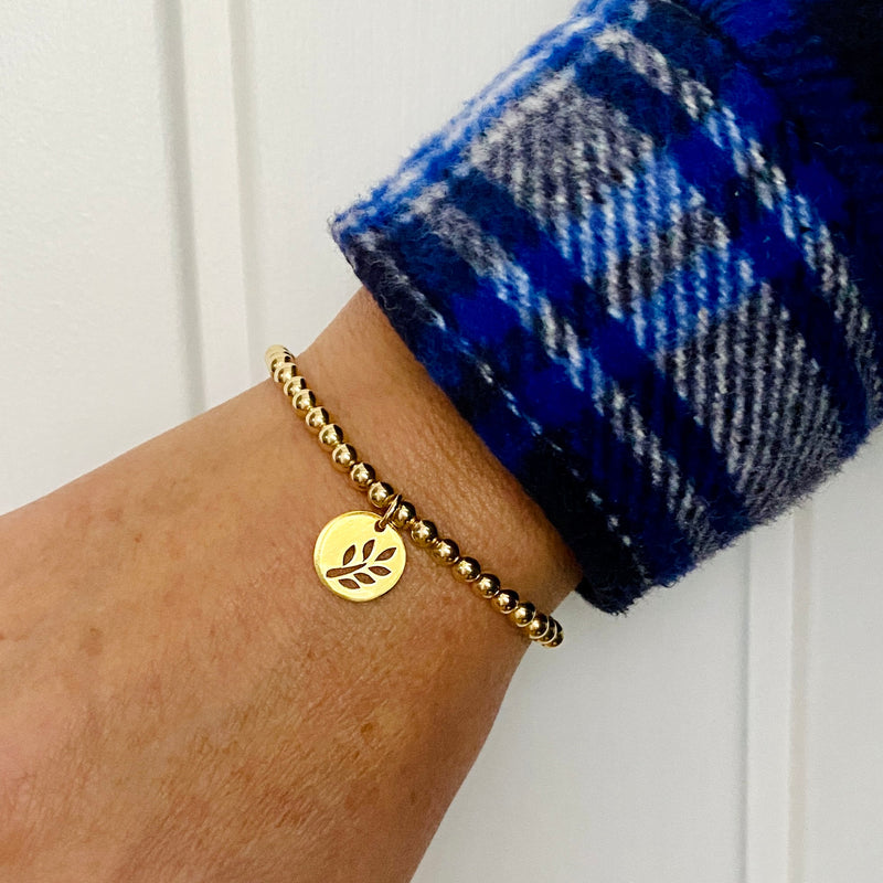 Gold Bracelet with Gold Leaf Charm. Cut out leaf charm bracelet.