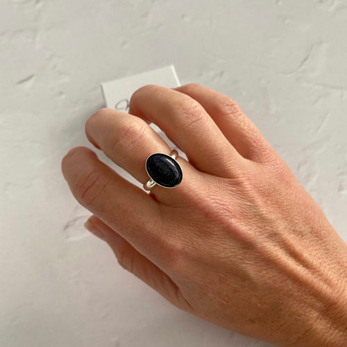 Sparkly blue goldstone gemstone in adjustable ring base in sterling silver. KookyTwo jewellery.