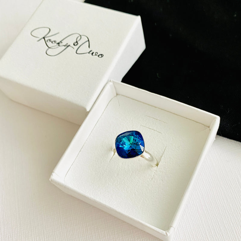 Stunning blue crystal ring with adjustable band in sterling silver, comes in gift box.