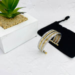 Mixed metal bracelet design with slim silver and gold bands in a cuff style to be easily adjusted. KookyTwo.
