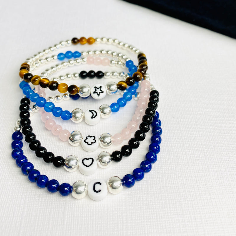 Customised gemstone bracelets with star bead, moon bead, heart bead, flower bead or letter bead in a variety of different colours.