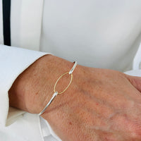 Gold Eternity Charm Bangle. Bracelet for women in mixed metal design.