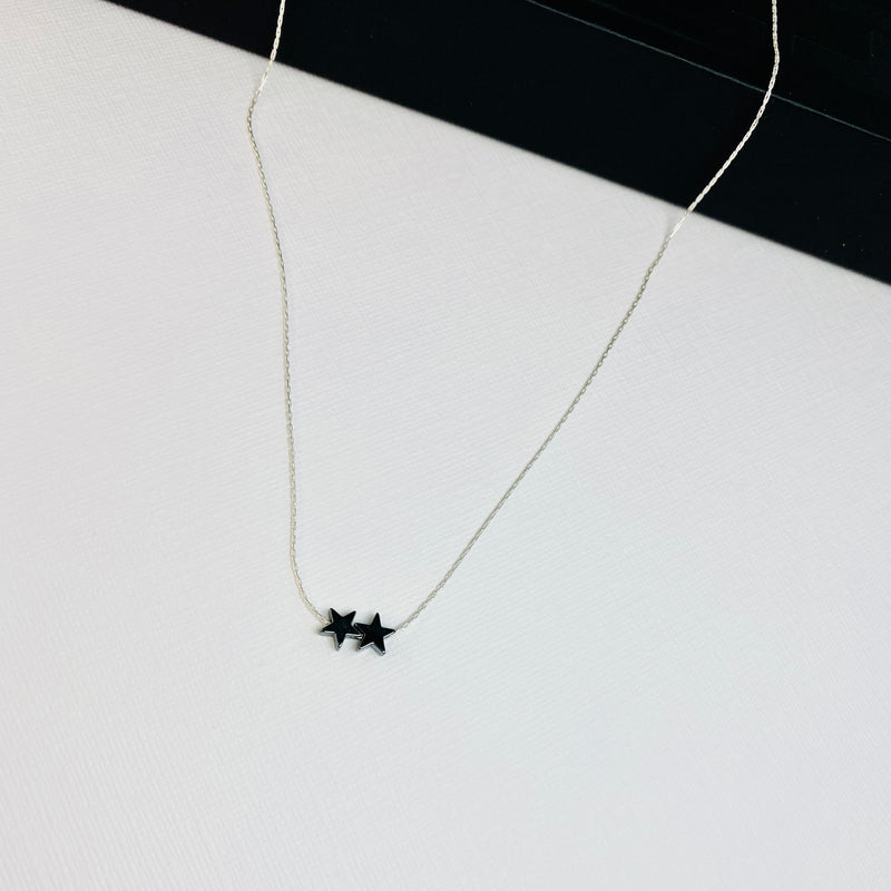 Two delicate black hematite star beads on dainty sterling silver chain. Kooky Two.