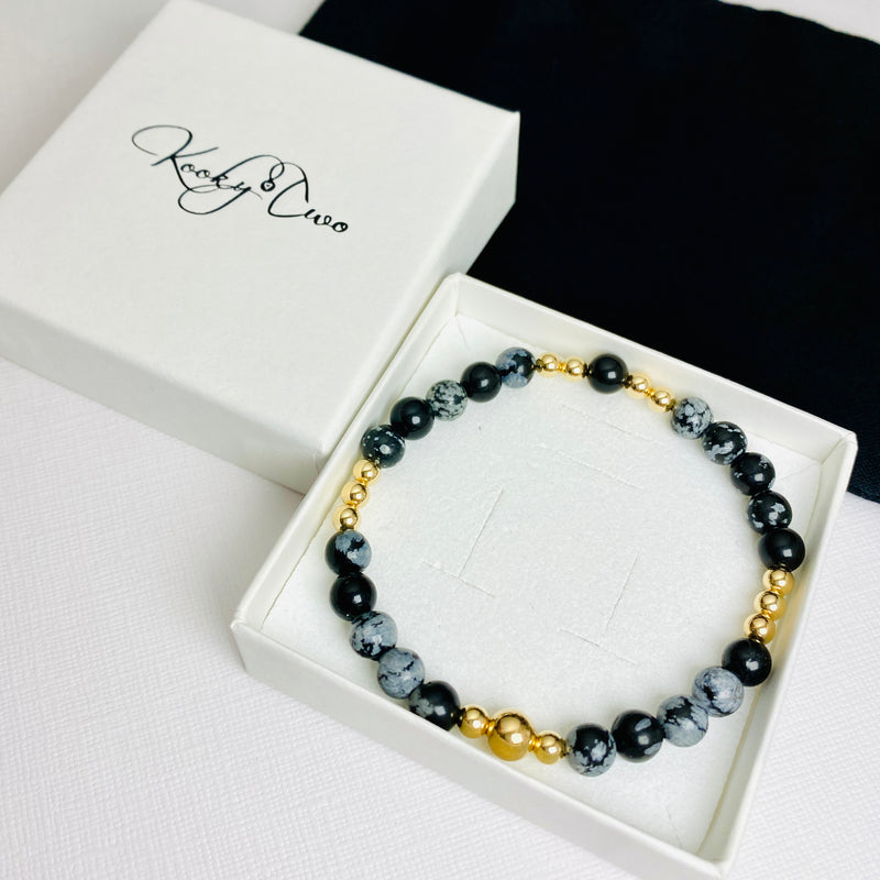 Snowflake obsidian bracelet with gold beads arrives in a white gift box.