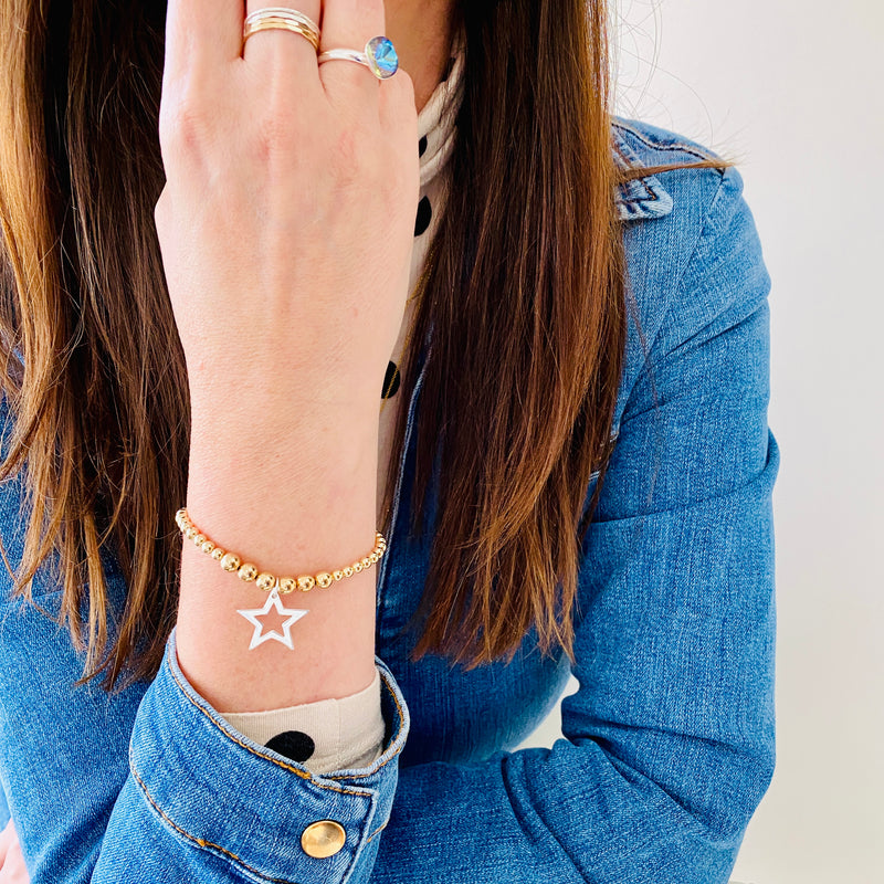 Statement bead bracelet with gold beads and silver star charm.