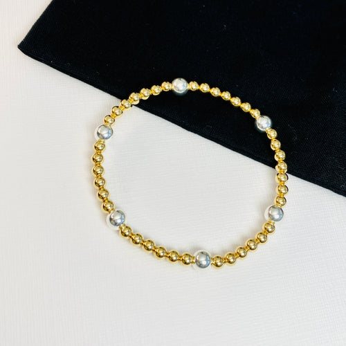 Shiny gold bracelet with an accent of sterling silver beads..