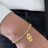 Gold bead bracelet with gold hamsa hand charm. Beads are 14k gold filled. Charm is 14k gold filled.