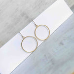 14k gold filled hoop drop earrings. Fish hook style earrings with circle charms in gold.