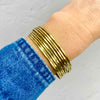 Gold summer bangle cuff bracelet with an open back to easily adjust. KookyTwo.