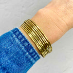 Gold summer bangle cuff bracelet with an open back to easily adjust. KookyTwo.