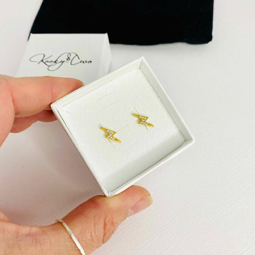 Gold sparkly lightning bolt stud earrings. KookyTwo