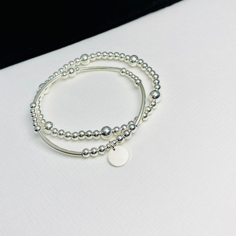 Silver stacking bracelet set with silver disc charm handmade with sterling silver beads.