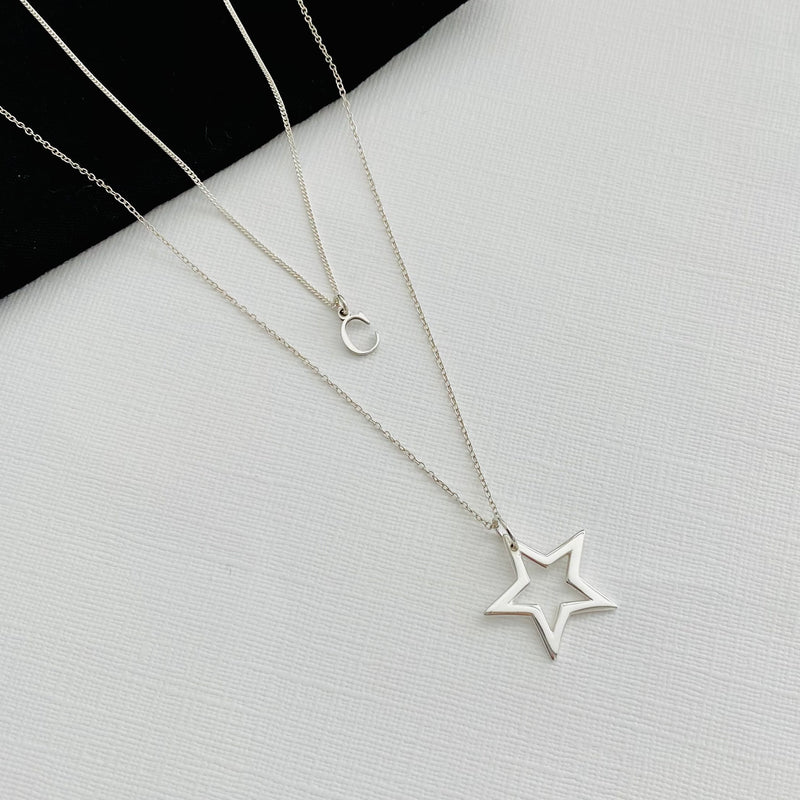Sterling silver necklace layering set, with dainty silver initial necklace and silver star charm necklace, in two different lengths. KookyTwo.