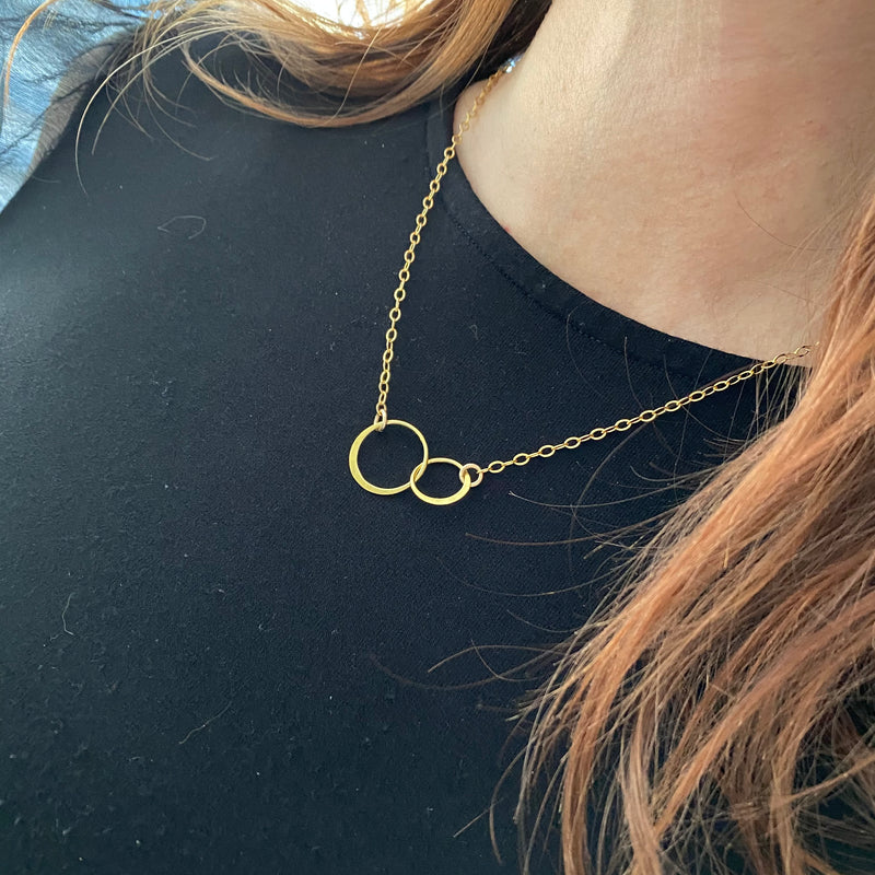 Eternity necklace in gold with interlocking rings to represent sisters. KookyTwo.