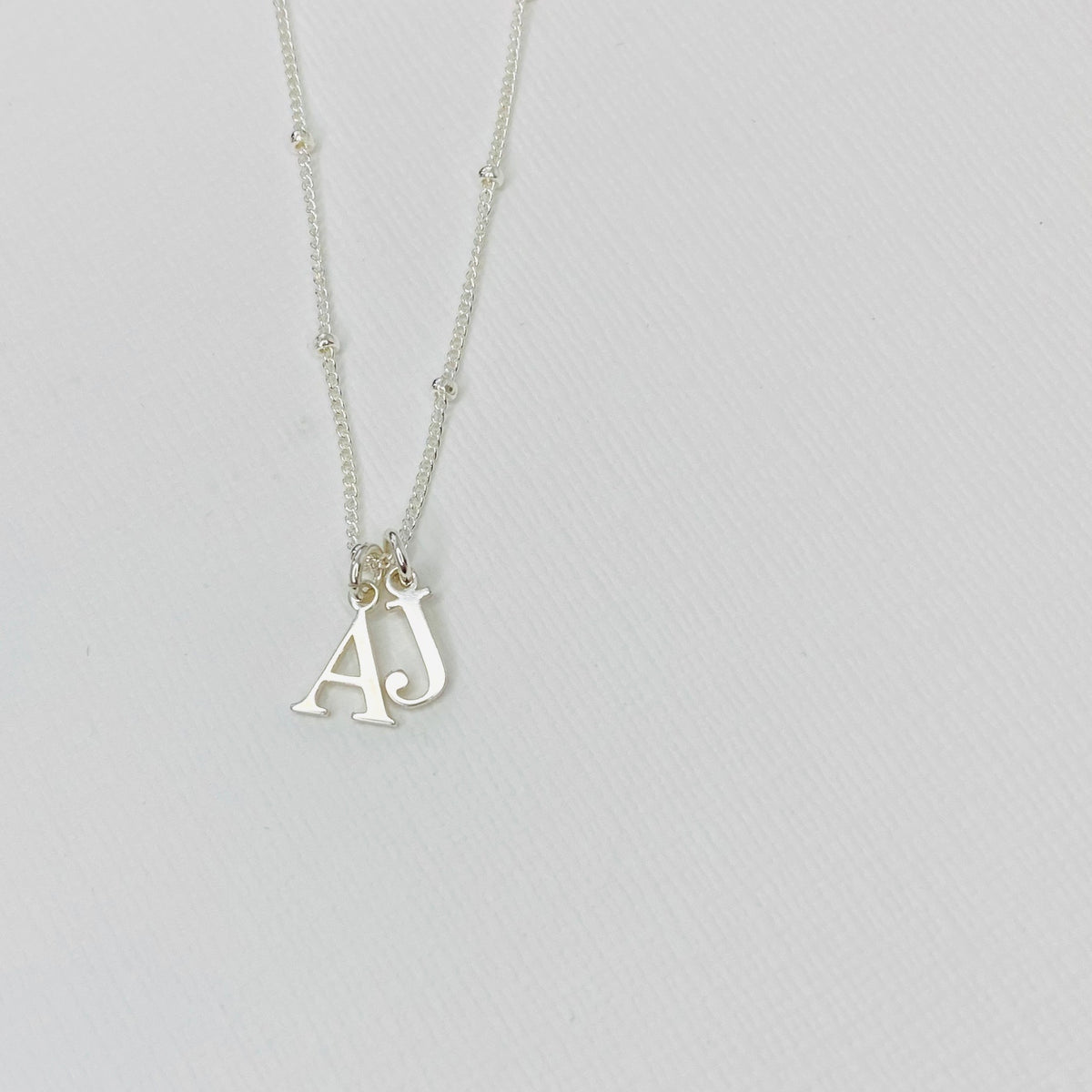 Silver necklace with two initials on Sterling Silver satellite chain.