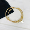 Gold bracelet stacking set handmade with 14k gold filled beads. Gold disc bracelet stacking set with set of two gold bracelets.