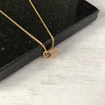 Five delicate gold rings on a gold chain - KookyTwo