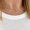 Dainty silver necklace with a simple silver bead.