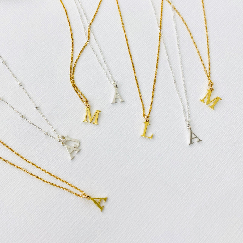 Initial necklaces with letter charms in sterling silver and gold. KookyTwo.