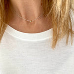 Dainty silver necklace with a simple bead in rose gold. Kooky Two.