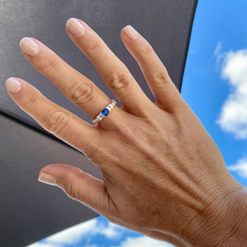 Bead ring made with elastic with sterling silver beads and blue gemstone bead.