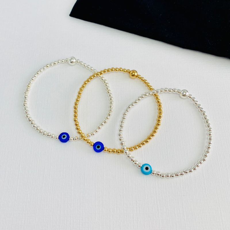 Hand beaded bracelets with evil eye beads.
