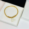Silver leopard charm on gold beaded bracelet. Cheetah charm on gold beaded bracelet. Gold bracelet with jaguar charm.