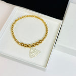 Silver leopard charm on gold beaded bracelet. Cheetah charm on gold beaded bracelet. Gold bracelet with jaguar charm.