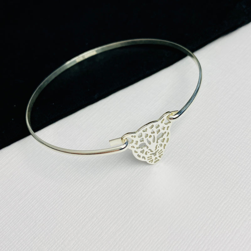 Silver bangle with leopard pendant for ladies who love animal print fashion.