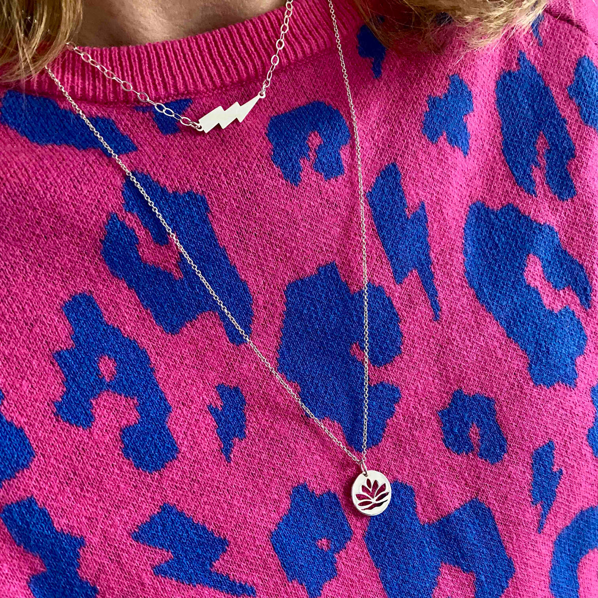 layering necklaces with lightning bolt charm and lotus flower charm in sterling silver. KookyTwo.