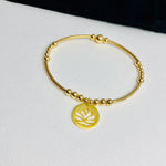 Handbeaded 14k gold filled bracelet with flower pendant.