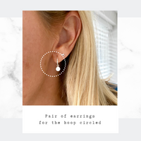 Mini hoop earrings with silver disc charm.