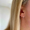 Silver mini hoop earrings with butterfly backs making them easy to wear. KookyTwo.