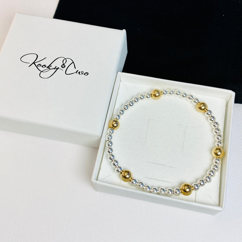 Thoughtful gift idea! A mixed metal sterling silver and gold bead bracelet with, displayed in gift-ready packaging. KookyTwo.