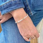 Denim style accessorised with a mixed metal bracelet.