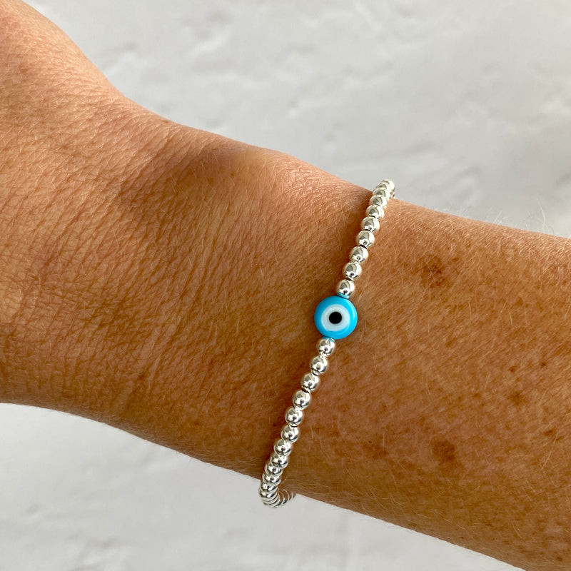 Pretty turquoise blue evil eye bracelet with turquoise blue evil eye bead and sterling silver beads.