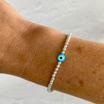 Pretty turquoise blue evil eye bracelet with turquoise blue evil eye bead and sterling silver beads.